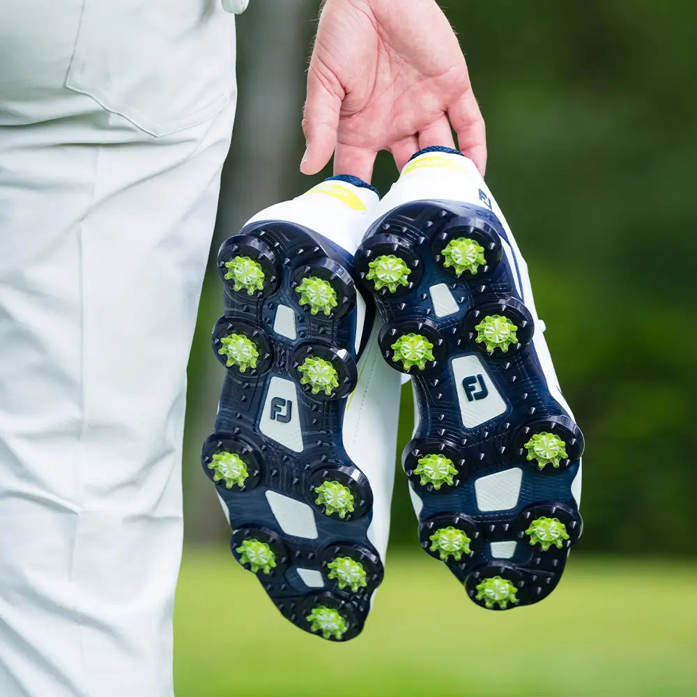 A man holding the slime green Pulsar soft spikes.