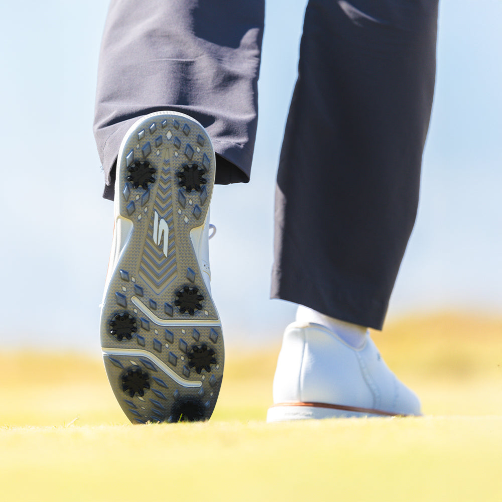 Close-up of a shoe sole with a brand logo on a blurred background