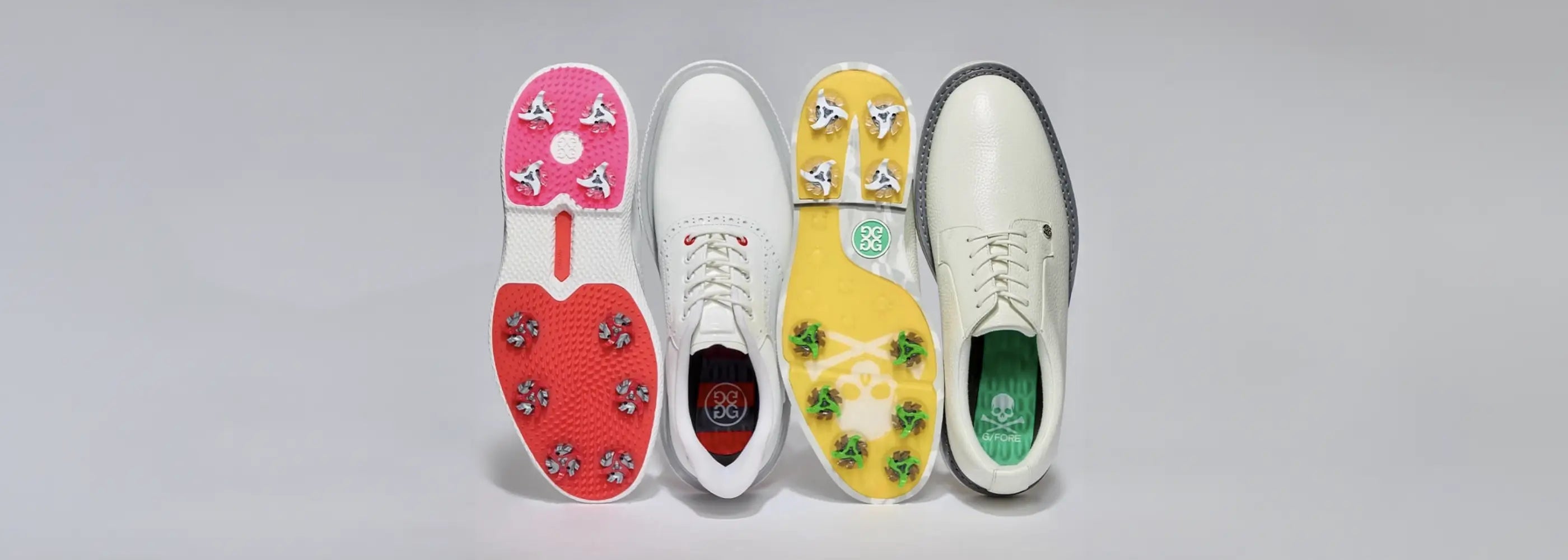 Two pairs of golf shoes with different softspike golf spikes attached to the bottom of the shoe. 