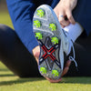 A person adjusting their golf shoe showing the green pivix golf spikes attached. 